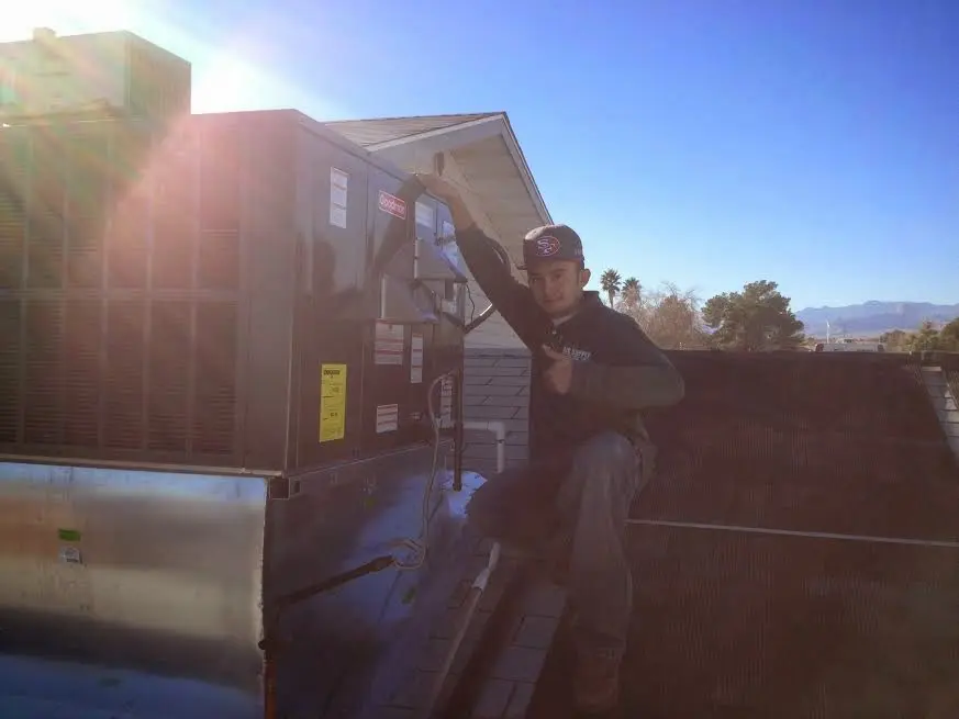 HVAC technician performing AC Tune-Up on a rooftop unit in Tunkhannock